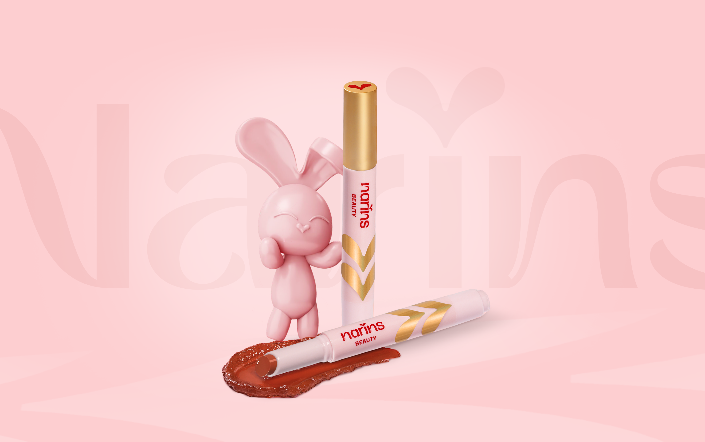 Pink rabbit figurine with two lip products on a pink background